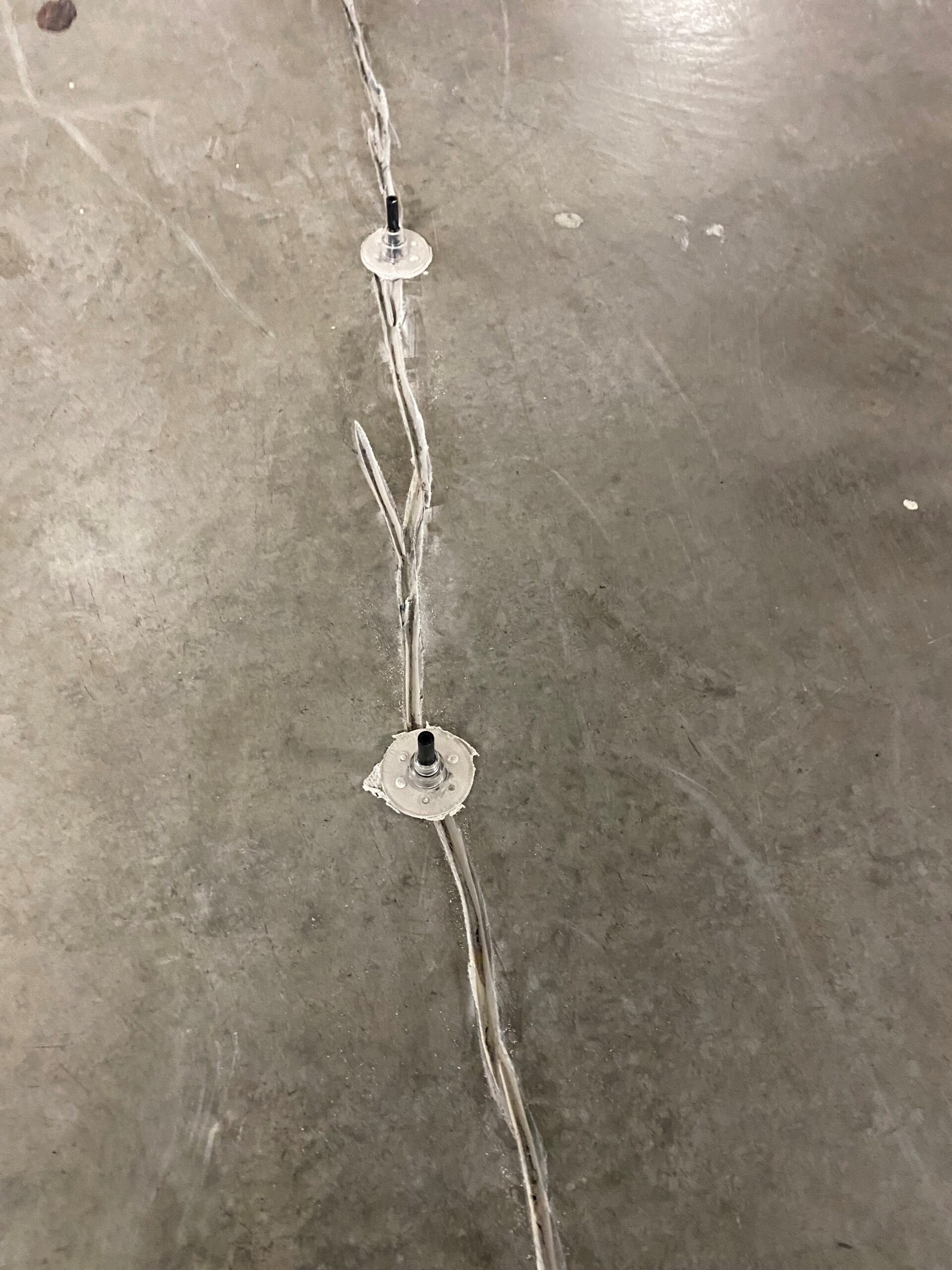Epoxy injection ports sealing a concrete crack
