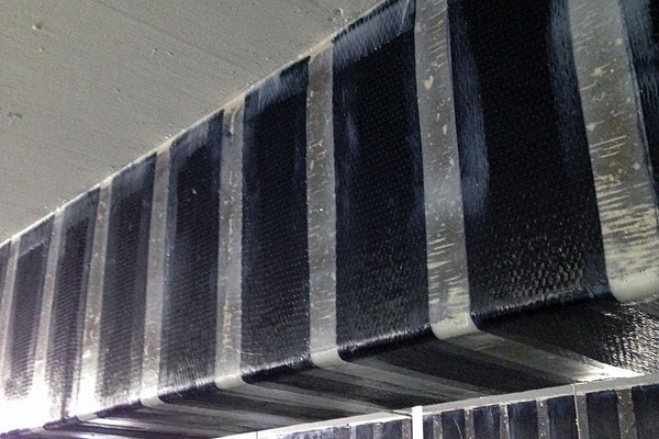 Carbon fiber strengthening wrap on a concrete beam