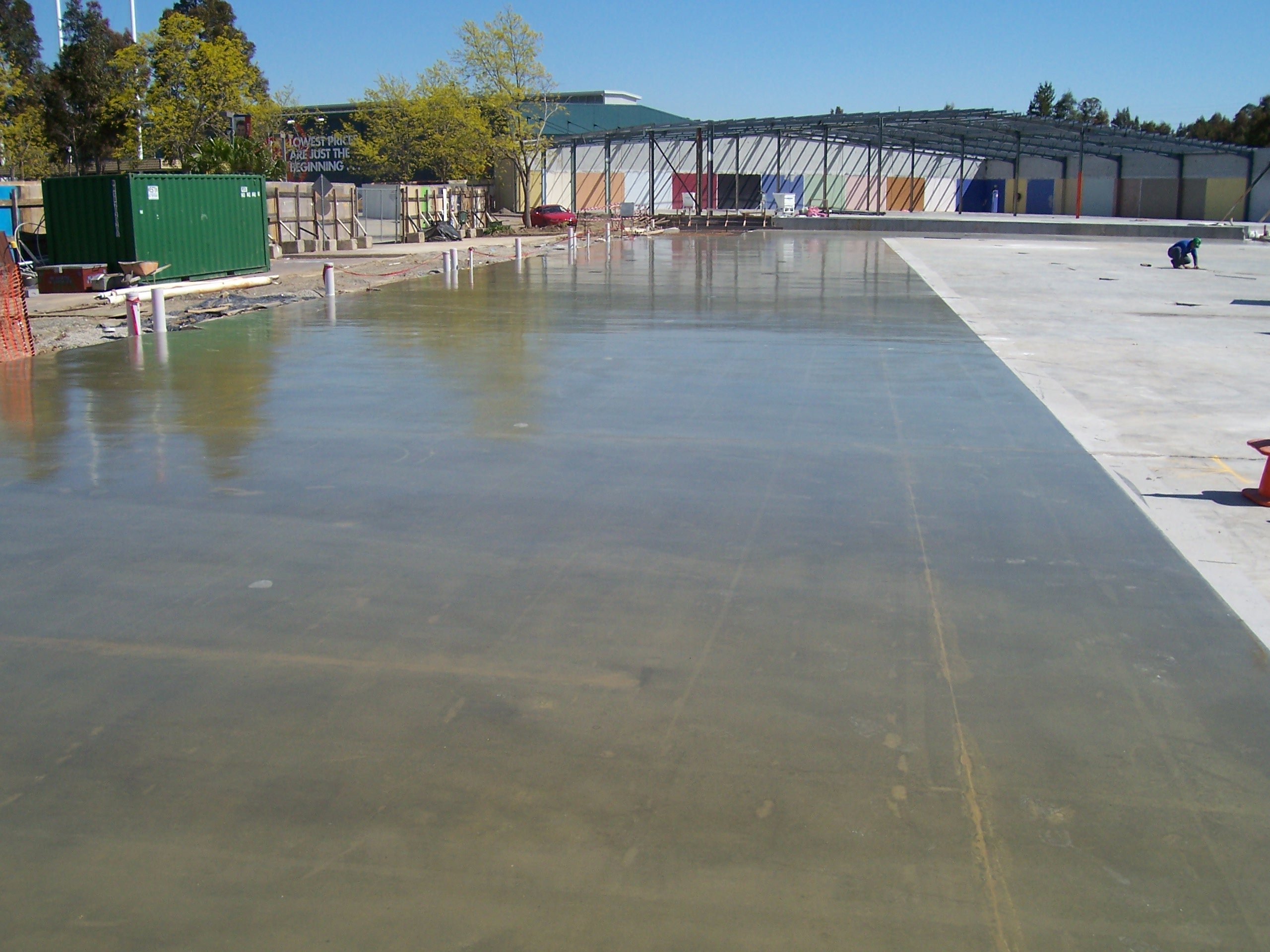 Large-scale concrete floor installation on a commercial construction site